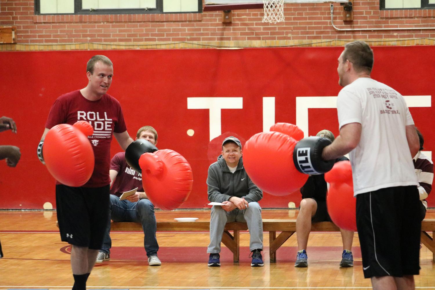 FIGHT-+Mr.+Nathan+Halenar+and+Mr.+Cody+Blankenhorn+help+fight+against+childhood+cancer+by+having+a+boxing+match+as+part+of+the+Mini-THON+fundraiser.+Students+cheered+on+their+favorite+teacher.+At+the+end+of+the+fight%2C+Mr.+Blankenhorn+won.+