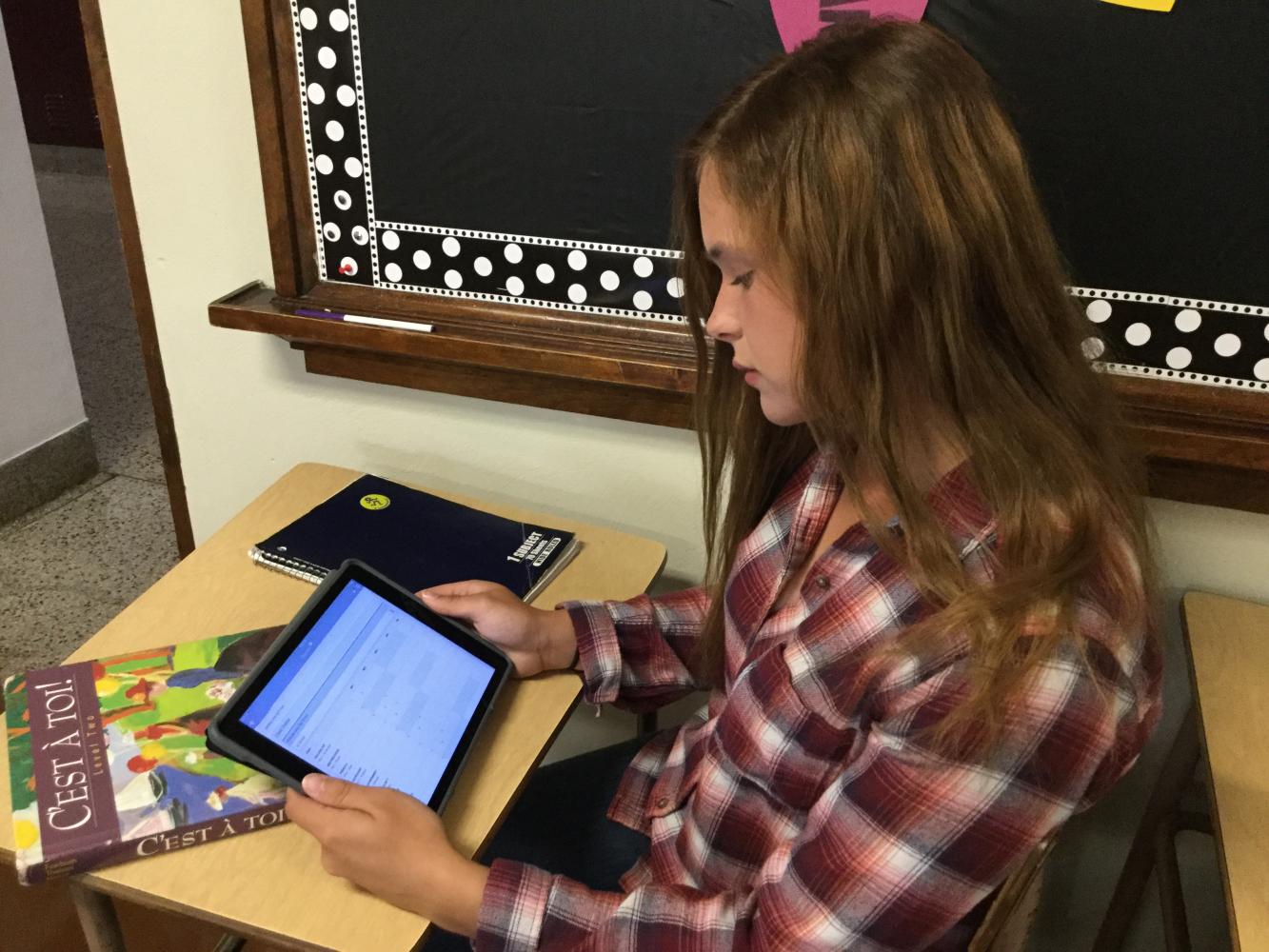 While sitting in class, senior Alyssa Vidal checks her grades on Skyward. Many students balance extracurricular activities with school. “I play tennis and I'm in the band. Sometimes it is really hard to maintain good grades, but in order for me to keep them up, I do my assignments as soon as possible. I also study as soon as I get the information,” Vidal said.