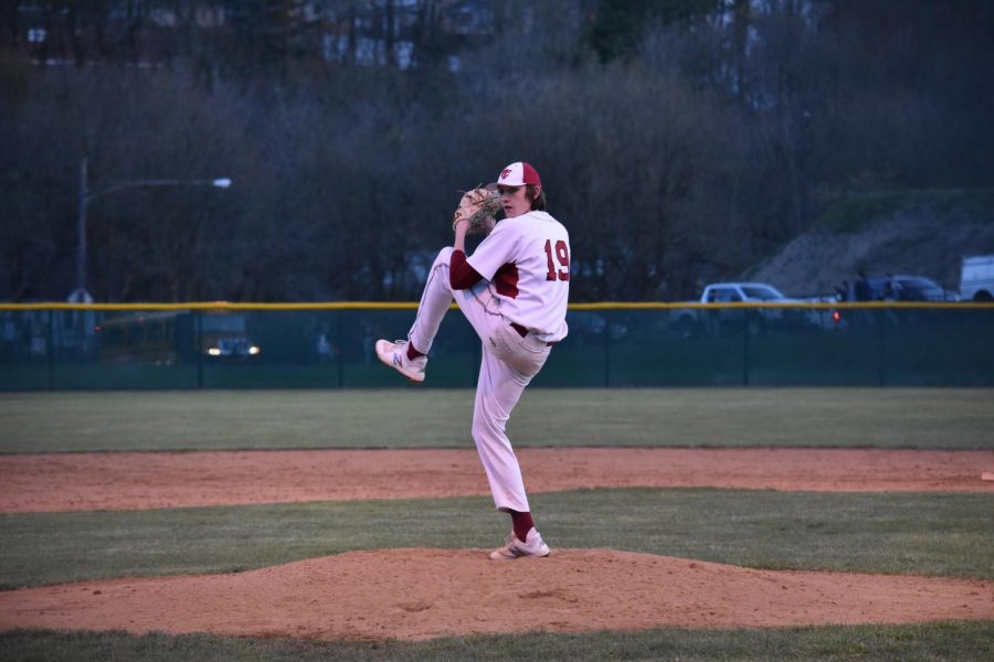Senior+Noah+Nabholz+winds+up+to+fire+a+pitch+during+a+game+at+Steidle+Field.+Nabholz+and+five+other+seniors+have+committed+to+college+to+play+a+sport.+%E2%80%9CI+chose+Shippensburg+because+they+showed+the+most+interest+in+me.+The+coaches+were+always+calling+and+texting+me%2C+asking+how+I+was+doing%2C%E2%80%9D+Nabholz+said.
