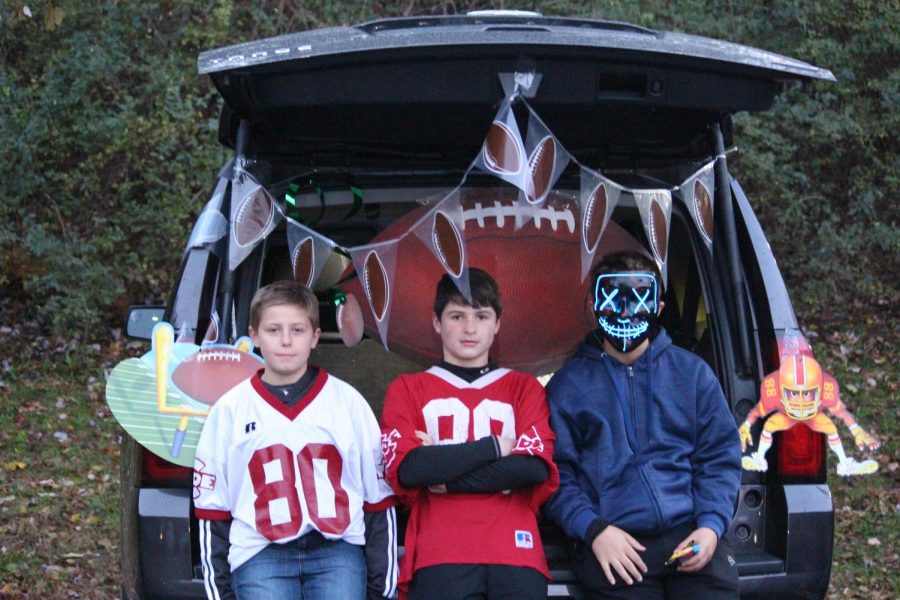 Henry+Mohl+%28middle%29+stands+at+his+football+themed+vehicle.+He+said%2C+%E2%80%9CThis+event+is+pretty+cool+and+it%E2%80%99s+safer+than+normal+trick-or-treating.%E2%80%9D%0A
