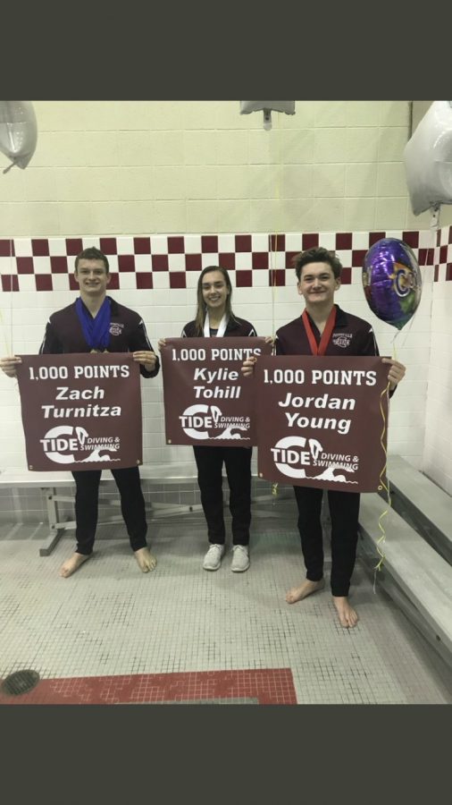Zachary+Turnitza%2C+Kylie+Tohill%2C+and+Jordan+Young+all+stand+together+holding+their+banners.+They+just+finished+competing+in+the+2019+District+XI+Swimming+Championships.+Senior+Zach+Turnitza+said%2C+%E2%80%9CYou+need+to+have+a+strong+team+to+achieve+1%2C000+points.%E2%80%9D