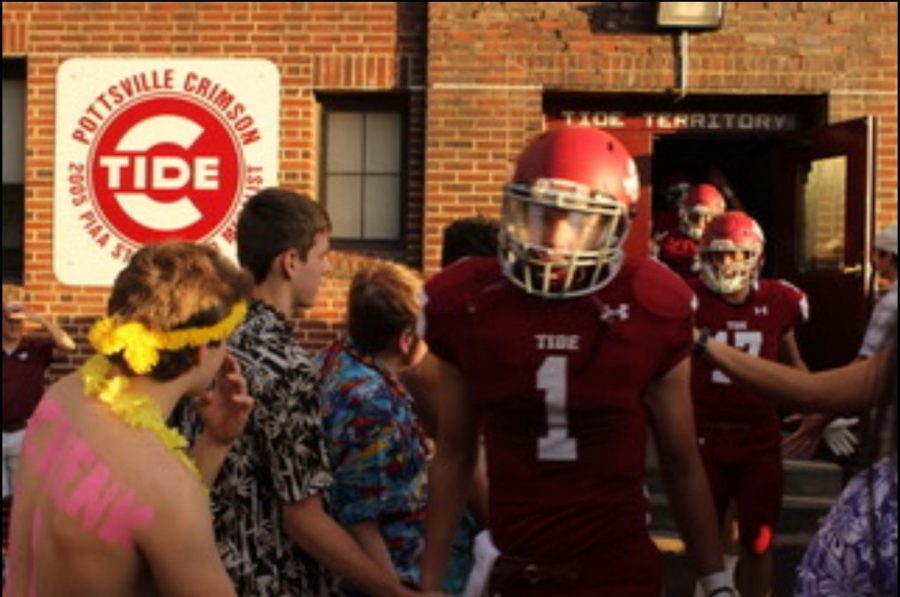 Patrick+Yoder+high+fives+a+student+from+PAHS+while+walking+out+of+the+locker+room+to+enter+the+football+field+at+Friday+night%E2%80%99s+game.+The+Crimson+Tide+ended+up+winning+against+Blue+Mountain+42-0.+%E2%80%9CWe+are+young+to+bring+the+energy+we+have+had+all+year+and+double+for+games+against+Blue+Mountain%E2%80%9D+said+Yoder.