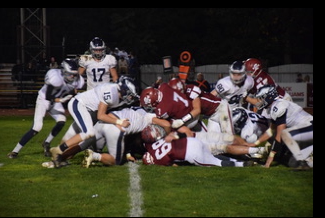 Crimson+Tide+Quaterback%2C+Damon+Yost+breaks+through+the+pile+of+players+to+score+a+Tide+touchdown+against+Blue+Mountain.+Pottsville+ended+the+season+with+a+close+game+against+Jersey+Shore%2C+losing+42-35.+Damon+said%2C+%E2%80%9CI%E2%80%99ve+been+playing+football+for+5+years%2C+and+what+I+love+most+is+the+bond+you+grow+with+your+teammates.%E2%80%9D