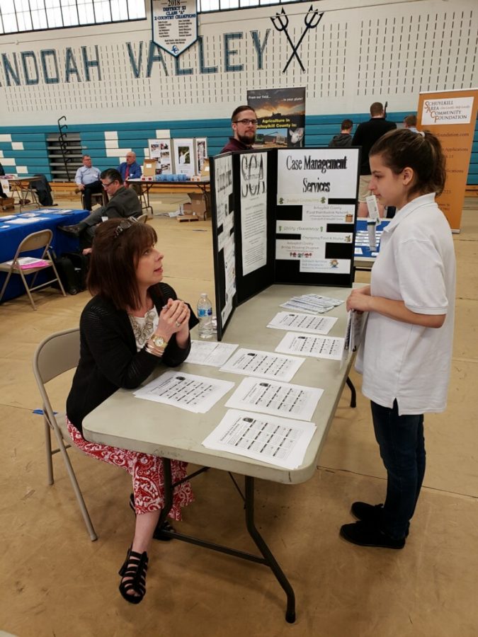 A+Pottsville+student+learns+about+the+Case+Management+Services+while+transition+fair+instructor+talks+to+her.%0A