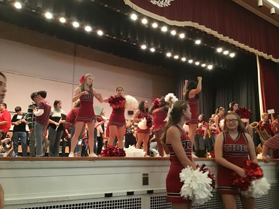 Cheerleaders+get+ready+to+perform+for+the+pep+rally+on+stage+in+the+auditorium.+Tiana+Green+said%2C+%E2%80%9C+My+favorite+cheer+we+perform+is+of+course+everyone%E2%80%99s+favorite+%E2%80%98Give+a+Yell%E2%80%99.+Everyone+goes+crazy+and+it%E2%80%99s+the+best+cheer+around+in+my+opinion%E2%80%9D.